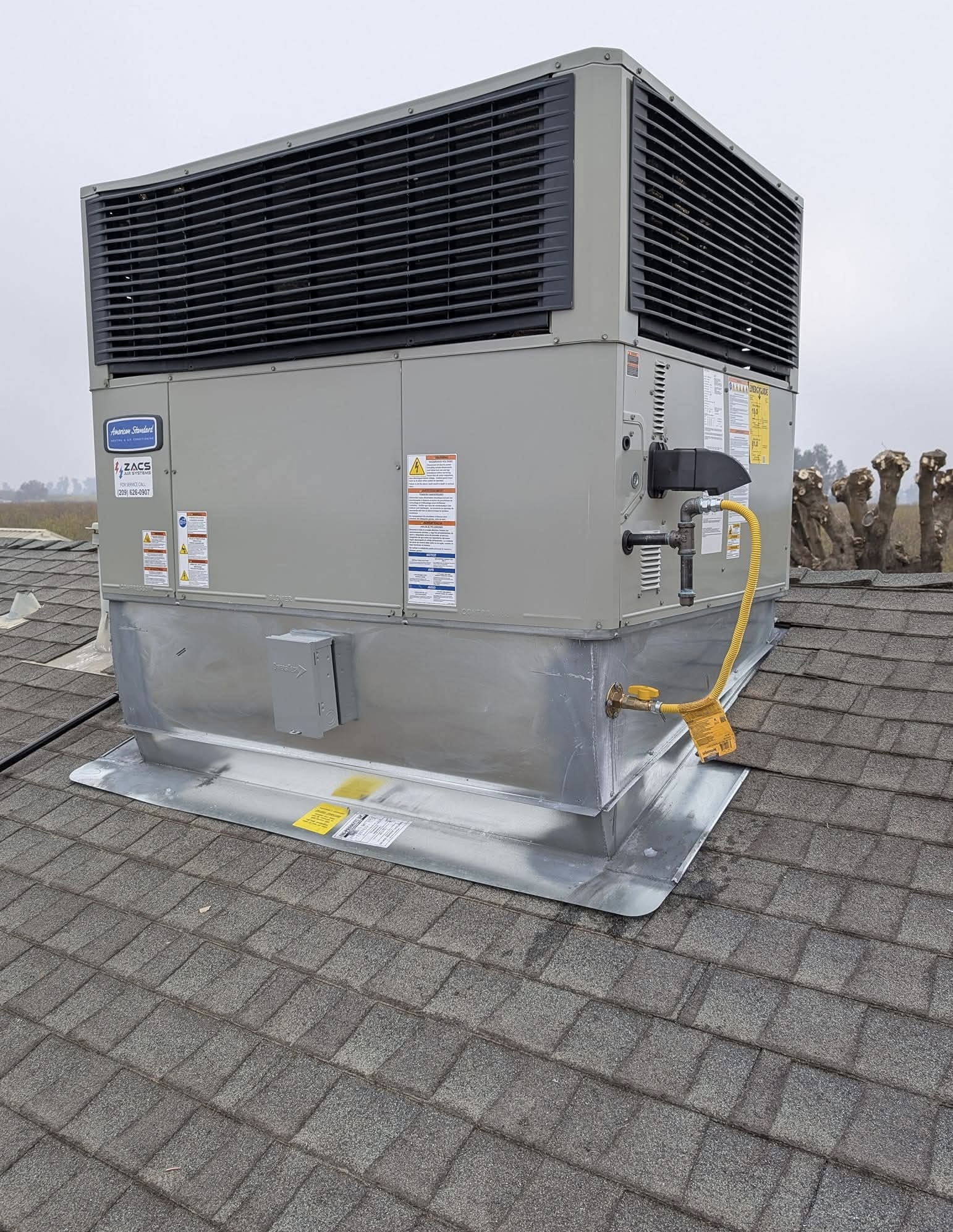 ZACS AIR SYSTEMS technician installing a ductless mini-split system in a Merced home